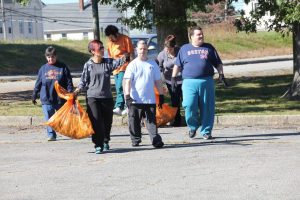 Groups of adults volunteering at a park cleanup
