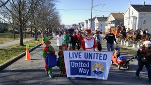 People dressed as elves and Mrs. Claus walking in the Fall River Children's Parade