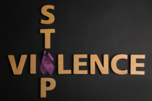 Stop Violence text with domestic violence awareness ribbon