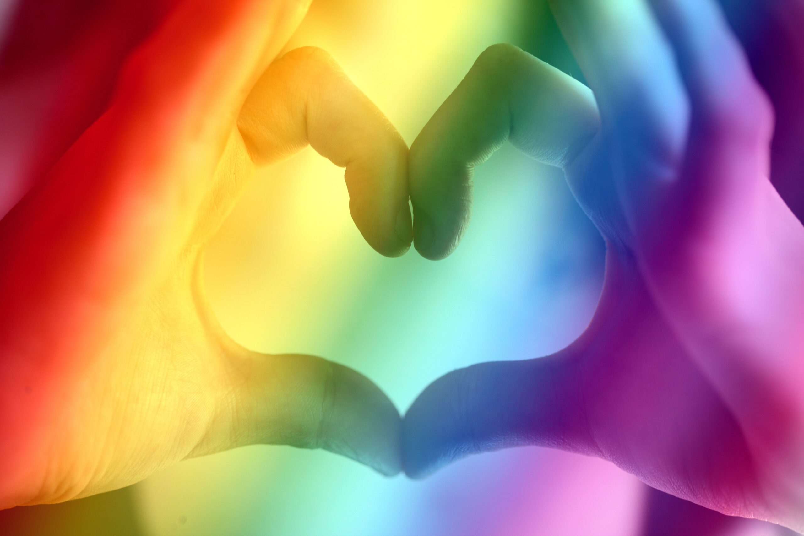 LGBTQ rainbow with hands making a heart