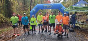 United We Move Trailfest Run. participants pose at race entrance
