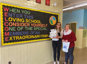 Teachers standing in front of bulletin board